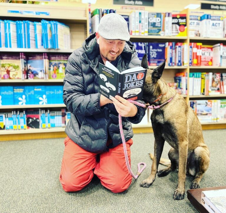 Quinn Collatt in a local bookstore during a dog socialization field trip